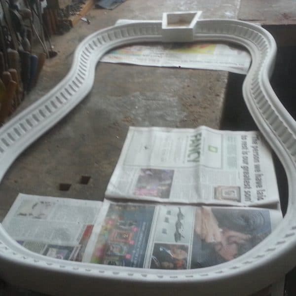 Hand carved fluted and shaped mirror frame